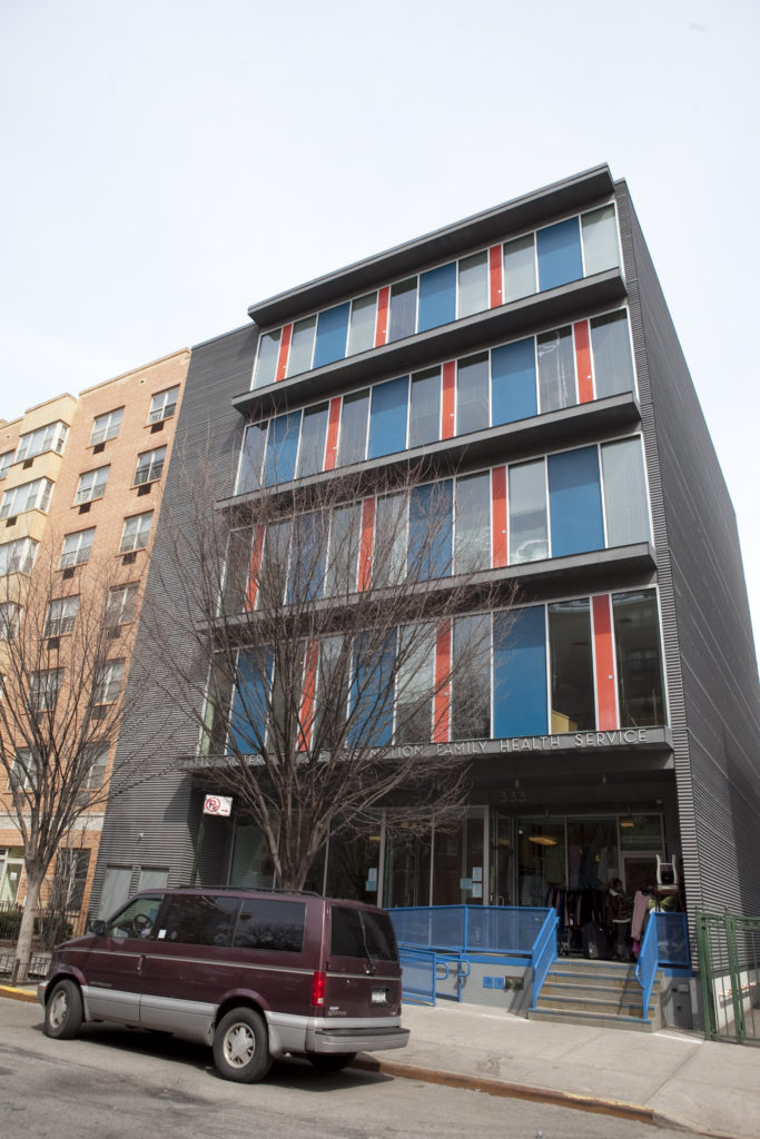 LSA Family Health Service building in East Harlem, New York, a four-story facility with blue and red glazed façade panels